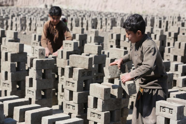 NANGARHAR, AFGHANISTAN - MARCH 15: Afghan labor at a brick kiln in the Surkh Rod district of Nangarhar province, Afghanistan on March 15, 2025, highlighting the ongoing struggle for survival amid economic hardship in the region. Children and adults work under harsh conditions, struggling to make ends meet. Child labor remains a widespread issue in the region, with many families forced to send their children to work in these demanding jobs to meet basic needs. (Photo by Sahfiullah Kakar/Anadolu via Getty Images)