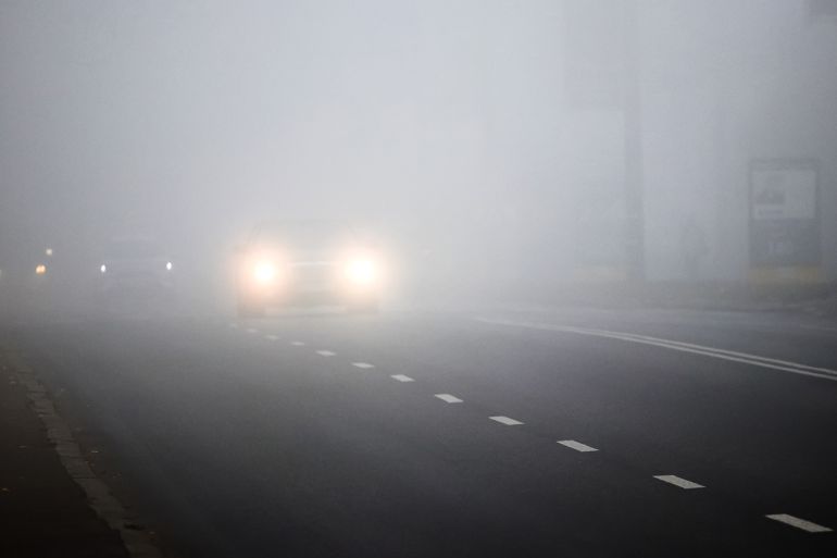 Motion of cars with headlights on during heavy fog_ by Volodymyr ادوبي ستوك