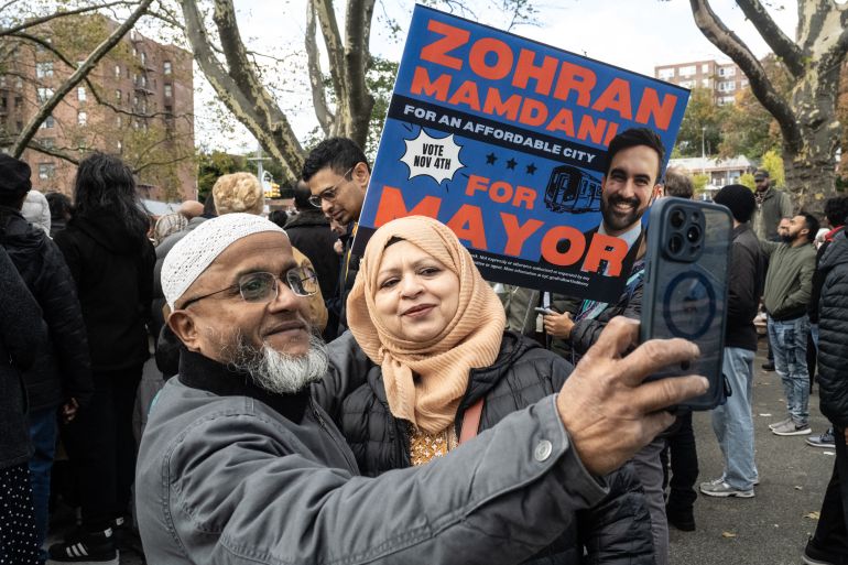 afp_690739cc4a5d-1762081228 NEW YORK, NEW YORK - NOVEMBER 1: Supporters of Democratic New York City mayoral candidate Zohran Mamdani pose for a selfie during a campaign event with Mamdani and New York City elected officials on November 1, 2025 in the Queens borough of New York City. With only days left in the race for New York City's next mayor, Mamdani remains the front runner against Independent candidate, former New York Gov. Andrew Cuomo and Republican candidate Curtis Sliwa. Stephanie Keith/Getty Images/AFP (Photo by STEPHANIE KEITH / GETTY IMAGES NORTH AMERICA / Getty Images via AFP)