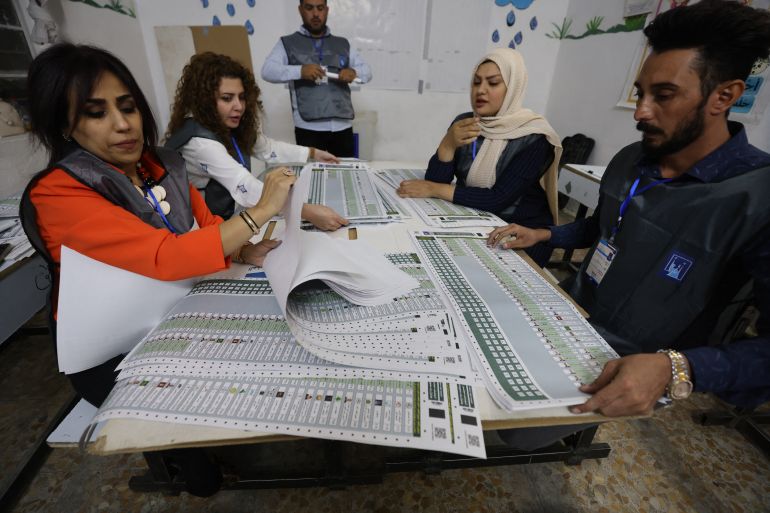 afp_691452f3efb0-1762939636 Iraqi polling officials count ballots at a polling station after closing of the polls during the country's parliamentary election in Al-Muhandiseen district in eastern Baghdad on November 11, 2025.