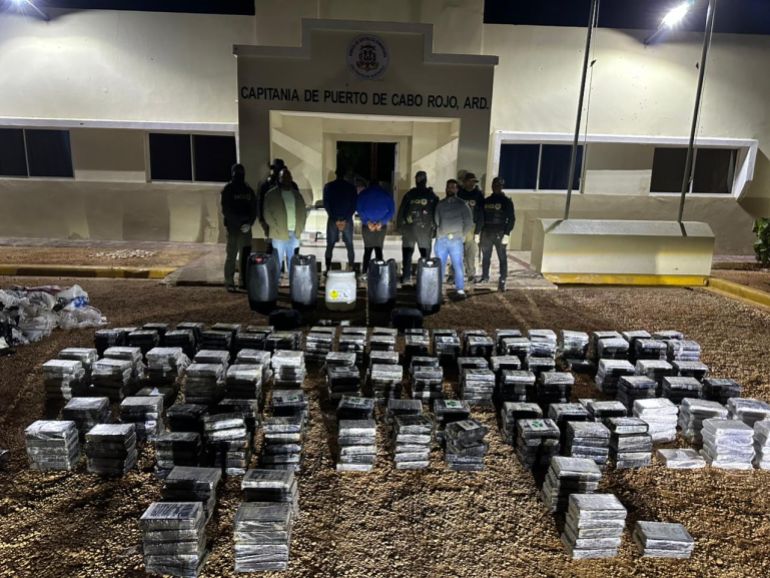 Handout picture released by the National Drug Control Directorate (DNCD) shows police officer next to alleged cocaine packs in Santo Domingo on November 15, 2025.