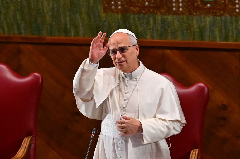 afp_69195a43b63c-1763269187 Pope Leo XIV gives his blessing during the opening of the Dies Academicus, the official inauguration of the 2025-2026 Academic Year at the Aula Magna of the Pontifical Lateran University which, in a special capacity, constitutes the 'Pope's University' in Rome, on 14, 2025. (Photo by Andreas SOLARO / AFP)