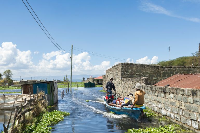 afp_691f0f2125c3-1763643169 Boat operators ferry a man and his household belongings after he was forced to evacuate his flooded residence at Kihoto estate in Naivasha on November 17, 2025.