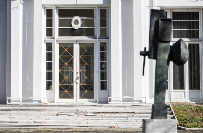 afp_692048f10184-1763723505 A government seal is posted above a weathered door at the former Venezuelan Embassy in Washington, DC on November 14, 2025.