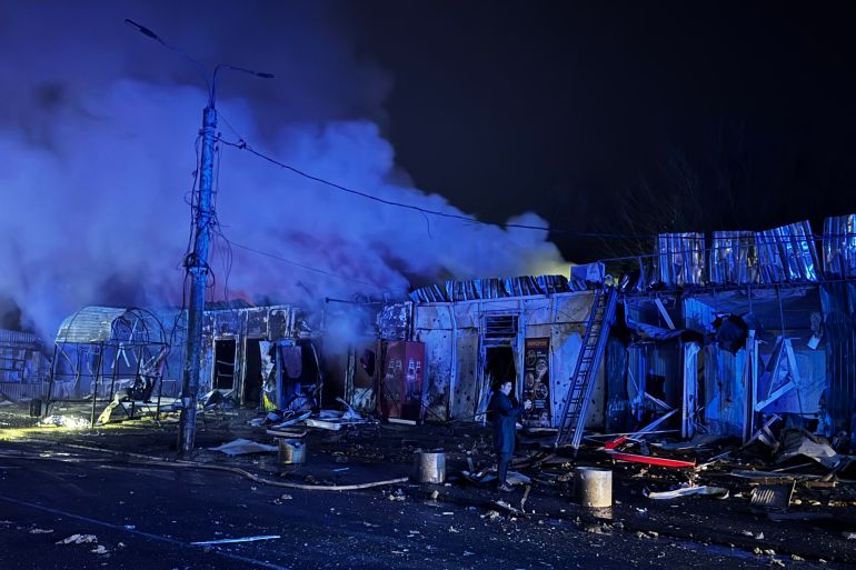 afp_692081bbd40e-1763738043 A man stands next to the site of an air attack in Zaporizhzhia, on November 20, 2025, amid the Russian invasion of Ukraine.