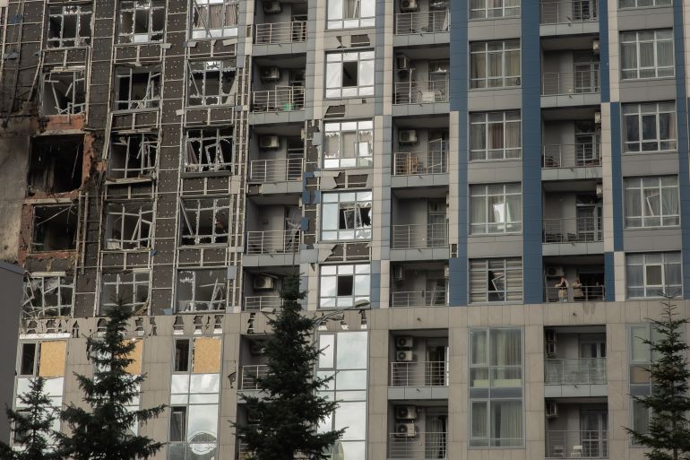 afp_69258e6b26d2-1764068971 Residents stand inside a damaged residential building following missiles and drones strikes in Kyiv on November 25, 2025, amid Russian invasion in Ukraine.