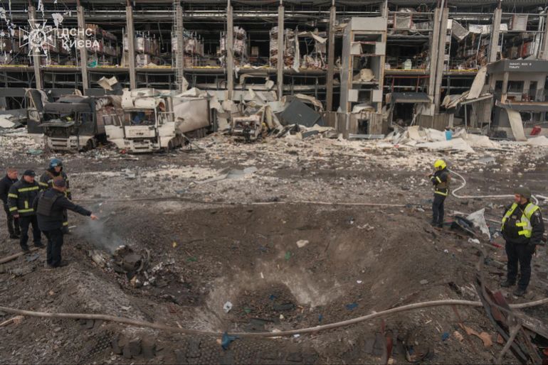 afp_69258e757d70-1764068981 In this handout photograph taken and released by the Ukrainian Emergency Service on November 25, 2025, Ukrainian law enforcement officers inspect a crater at the site of an air attack in Kyiv, amid the Russian invasion of Ukraine.