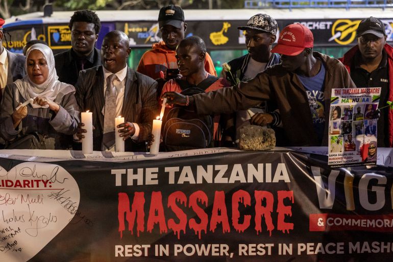 afp_6927e6466afc-1764222534 Protesters hold candles and banners during a memorial vigil to honour Tanzanians killed during post-election unrest, in Nairobi, on November 20, 2025.