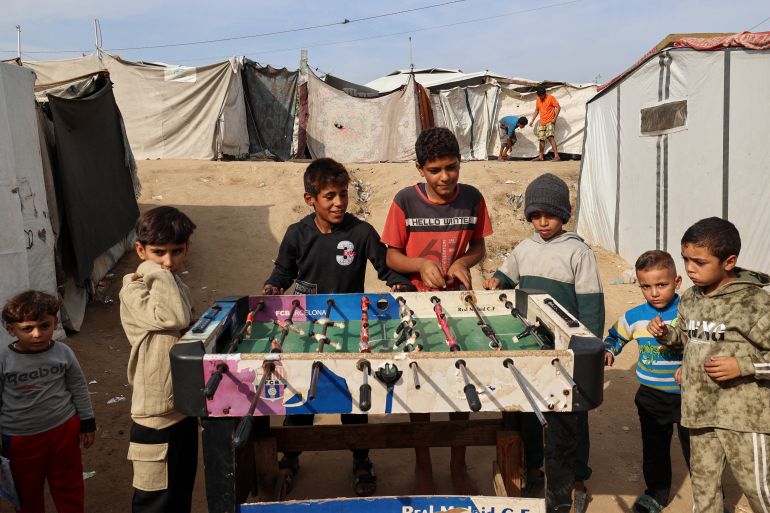 afp_692c0342cfa7-1764492098 TOPSHOT - Children play table football at the Nuseirat camp for displaced Palestinians in the central Gaza Strip on November 29, 2025.