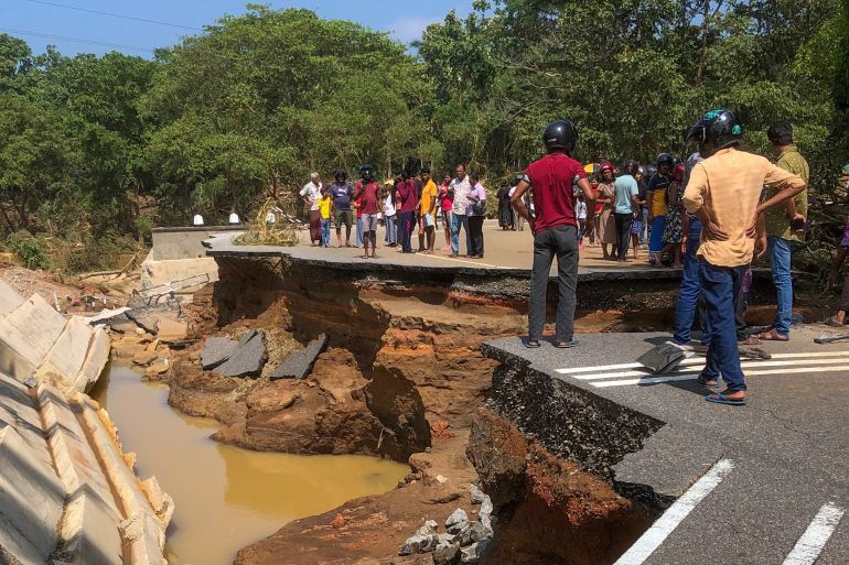 afp_692c76009466-1764521472 People gather around the Deduru Oya Bridge, which collapsed after floods in Kurunegala on November 30, 2025.