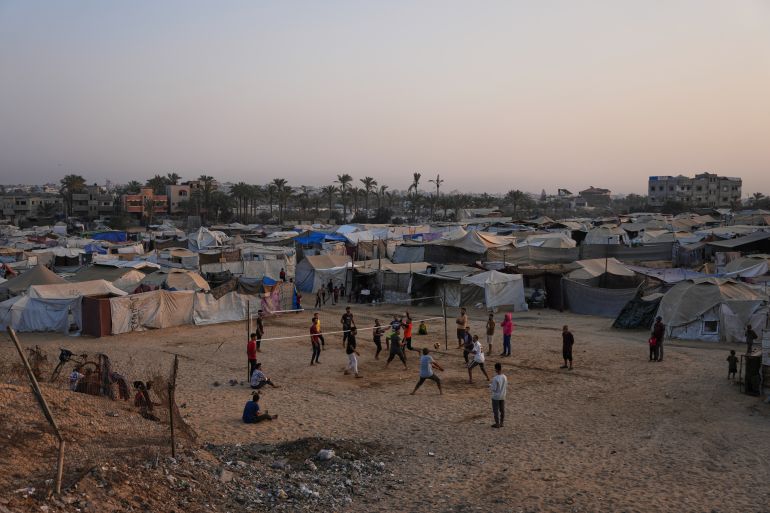 Young Palestinians play volleyball at a tent camp for displaced people in Zawayda, in the central Gaza Strip, Tuesday, Nov. 4, 2025.(AP Photo/Abdel Kareem Hana)