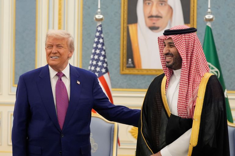 ap_691c8cd27d56a-1763478738 FILE - President Donald Trump and Saudi Crown Prince Mohammed bin Salman gesture as they meet delegations at the Royal Palace in Riyadh, Saudi Arabia, May 13, 2025. (AP Photo/Alex Brandon, File)