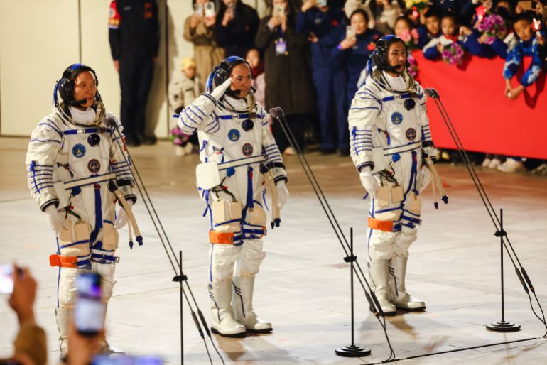 epa_690546f61c8d-1761953526 epa12495378 Astronauts of the Shenzhou-21 space mission (L-R) Zhang Hongzhang, Zhang Lu and Wu Fei, salute during the seeing-off ceremony at the Jiuquan Satellite Launch Center near Jiuquan, China, 31 October 2025. EPA/WU HAO