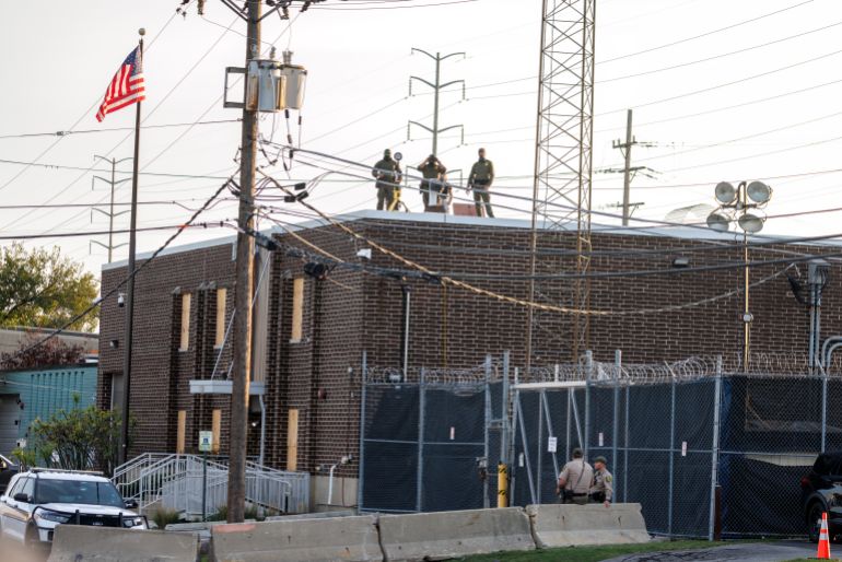 epa_690a7d22b6c7-1762295074 epa12461511 Masked ICE officers observe the crowd from the roof of the ICE detention facility in Broadview, around 12 miles west of Chicago, Illinois, USA, 17 October 2025. The demonstrations against the US Immigration and Customs Enforcement (ICE) are rooted in concerns about civil rights, local community safety, and alleged overreach by federal enforcement. EPA/CRISTOBAL HERRERA-ULASHKEVICH