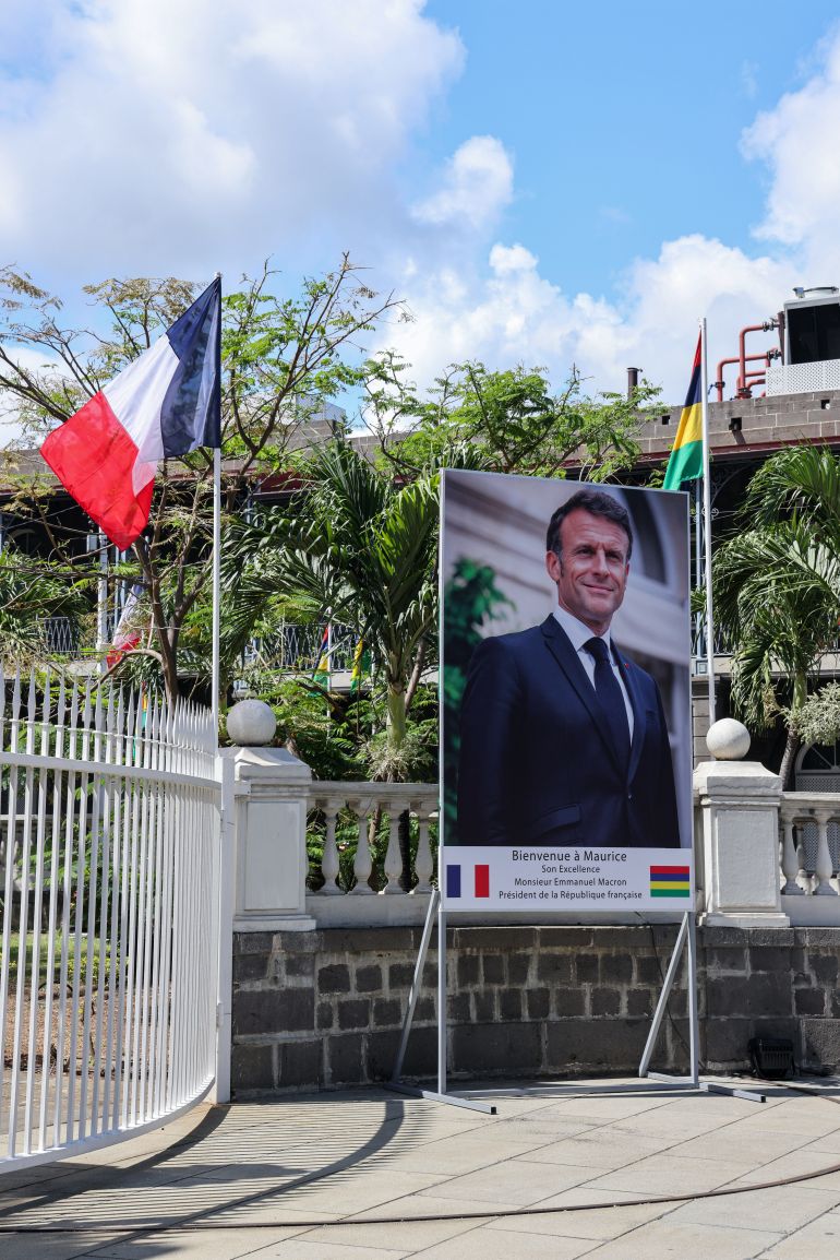 epa12537695 A portrait of French President Emmanuel Macron is displayed in Port Louis, Mauritius, 20 November 2025. The French president starts his five-day visit to Africa in Mauritius before attending the G20 Summit in Johannesburg and then visiting Gabon and Angola. EPA/PETER L M HOUGH