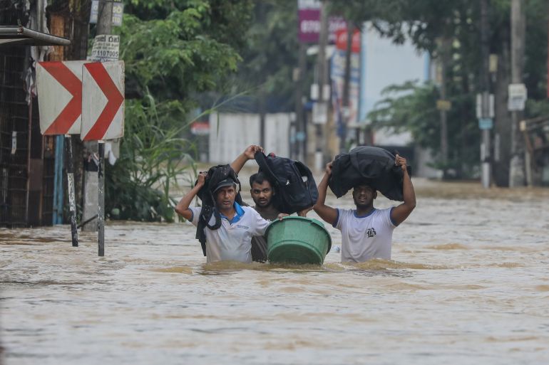 epaselect epa12556562 Sri Lankan flood victims wade through a flooded road during heavy rainfall in a suburb of Colombo, Sri Lanka, 29 November 2025. Many parts of the island have been inundated due to heavy rains. According to Sri Lanka’s Disaster Management Centre, more than 120 people have been killed and about 130 are missing across the country. EPA/CHAMILA KARUNARATHNE