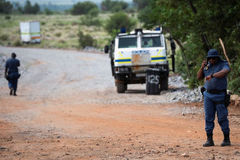 fde-2-1736933161 Members of the South African police patrol as they guard the mine shaft where rescue operations are ongoing as attempts are made to rescue illegal miners who have been underground for months in Stilfontein, South Africa, January 14, 2025. REUTERS/Ihsaan Haffejee