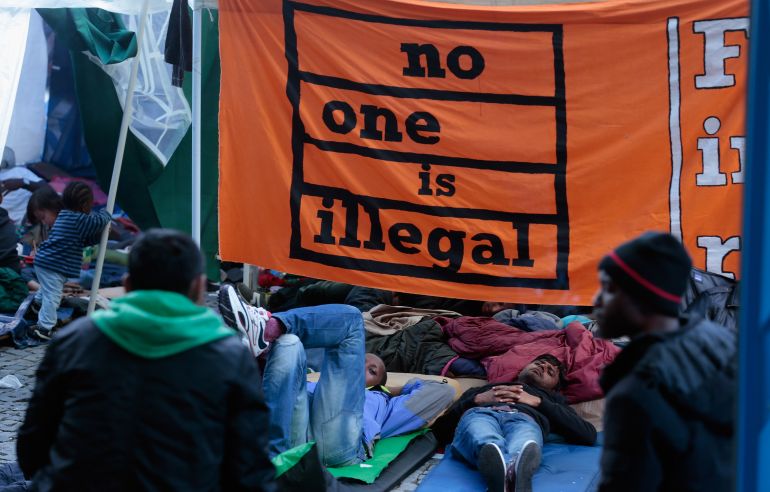 MUNICH, GERMANY - JUNE 28: Asylum seekers mainly from Pakistan and Nigeria lie on blankets in a tent while continuing their hunger strike in the city center on June 28, 2013 in Munich, Germany. At least 19 of the hunger strikers have been taken to hospital since they began refusing liquids last Tuesday, and many of them have threatened to commit suicide if their demand for political asylum in Germany is not met. German authorities have so far refused to grant them asylum. (Photo by Johannes Simon/Getty Images)