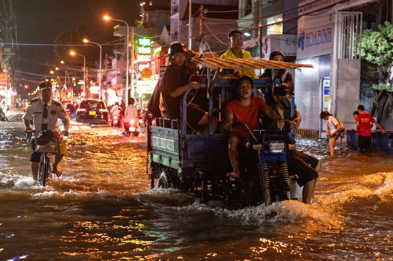 HO CHI MINH CITY, VIETNAM - NOVEMBER 6: A man rides a truck on the street as water levels reach the annual peak on November 6, 2025 in Ho Chi Minh City, Vietnam. Ho Chi Minh City is one of the world’s fastest-sinking coastal cities and has seen worsening flooding due to climate change, rising sea levels, and rapid urbanization. According to the World Bank, a 40 cm rise in sea level could cause yearly losses of 1–5% of the city’s GDP. (Photo by Thanh Hue/Getty Images)