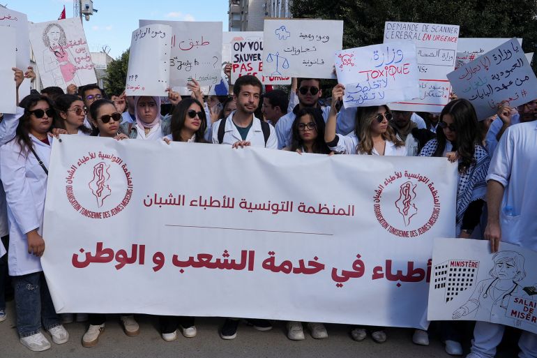 Young doctors gather and hold signs during a protest as thousands went on strike across Tunisia on Wednesday, demanding higher pay and warning of an impending collapse of the health system, part of a broader wave of social unrest convulsing the country, in Tunis, Tunisia, November 19, 2025. REUTERS/Jihed Abidellaoui