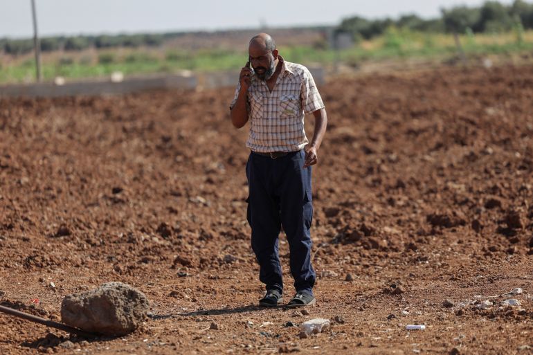 reuters_690f427d-1762607741 Faisal Sbeih, 46, who fled sectarian fighting in Syria's Sweida province, speaks on his mobile phone in the Daraa countryside, Syria, September 15, 2025. REUTERS/Khalil Ashawi