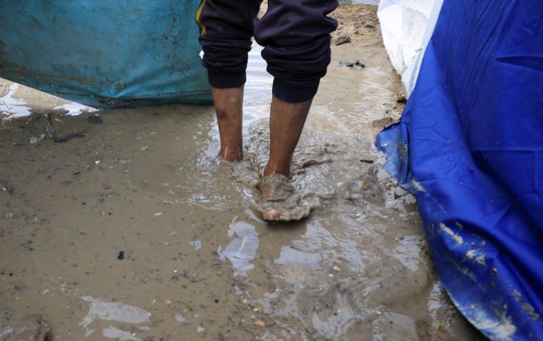 reuters_69197f7e-1763278718 A Palestinian man walks by tents through the wet ground on a rainy day, during a ceasefire between Israel and Hamas, in Gaza City, November 14, 2025. REUTERS/Dawoud Abu Alkas