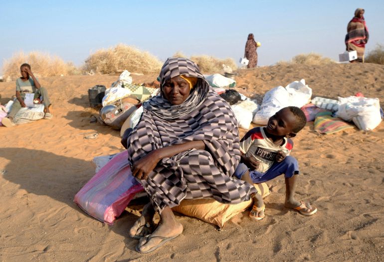 reuters_691f3741-1763653441 FILE PHOTO: A displaced woman from El Fasher sits with her child as they wait for permission to enter a camp in Al-Dabbah, Sudan, November 13, 2025. REUTERS/El Tayeb Siddig/File Photo