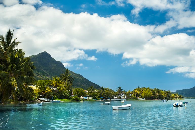 View of the mountain in Le Morne Brabant and the bay with boats on the island of Mauritius in the Indian Ocean.; Shutterstock ID 1929375977; purchase_order: aj; job: ; client: ; other: