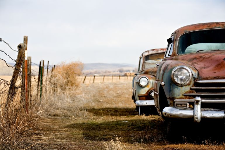 shutterstock_2767710-1762084975 vintage cars abandoned and rusting away in rural wyoming