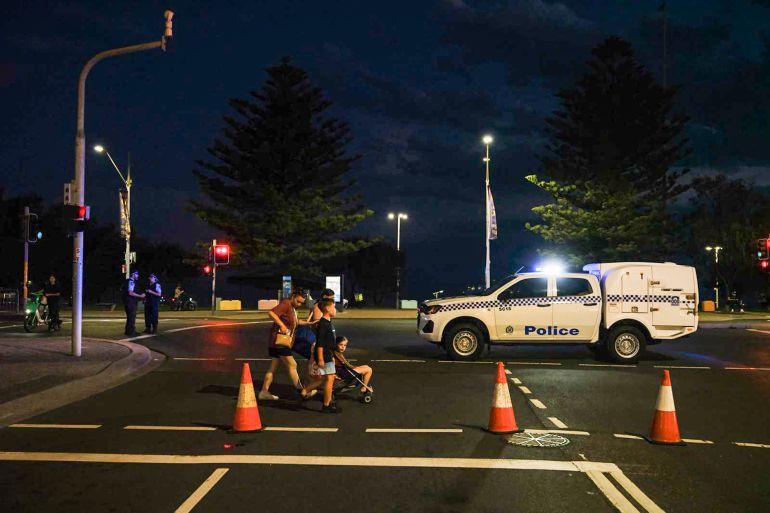 1sydney-1765706139 SYDNEY, AUSTRALIA - DECEMBER 14: Members of the public leave the scene after a shooting at Bondi Beach on December 14, 2025 in Sydney, Australia. Two gunmen dressed in black fired several shots at Sydney's world-famous Bondi Beach, causing at least 10 injuries and three deaths, and setting off mass panic on a Sunday evening. (Photo by George Chan/Getty Images)