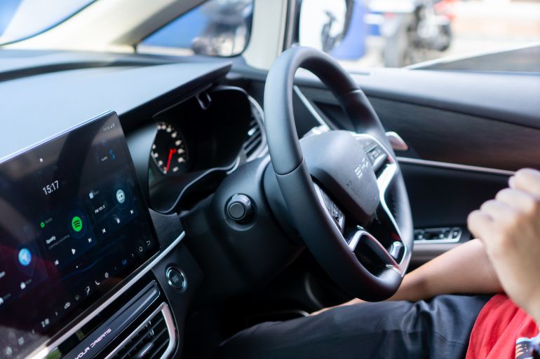 Jakarta, Indonesia-June 14, 2025: The car interior consists of a steering wheel with the BYD logo complete with functional control buttons.