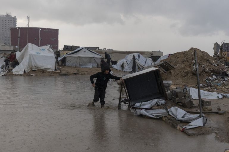 39-2-1765872205 GAZA CITY, GAZA - DECEMBER 15: Palestinians displaced by Israeli attacks struggle to carry out their daily lives under harsh conditions in makeshift tents in Gaza City, Gaza on December 15, 2025. Heavy rainfall and strong storms affect the Gaza Port area in western Gaza City, damaging tents where displaced Palestinians take shelter. Adverse weather conditions further exacerbate the hardships faced by displaced Palestinians living under severe humanitarian conditions. ( Mahmoud Abu Hamda - Anadolu Agency )