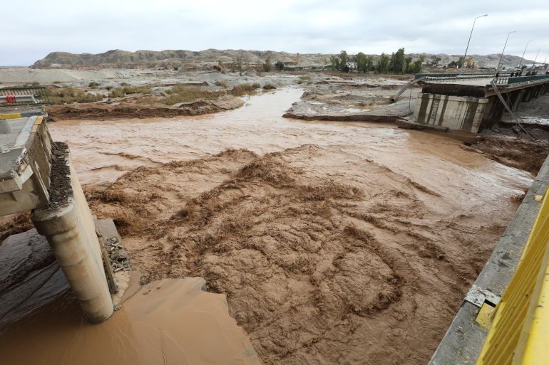 4iraq-1765368057 Water flows beneath the collapsed portion of a bridge linking Baghdad and Kirkuk, caused by heavy floods, in the Tuz Khurmatu district, Iraq, December 10, 2025. REUTERS/Ako Rasheed