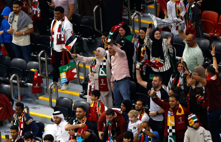 54-6-1764666456 Soccer Football - FIFA Arab Cup - Qatar 2025 - Group A - Qatar v Palestine - Al Bayt Stadium, Al Khor, Qatar - December 1, 2025 Palestine fans celebrate Palestine's first goal, an own goal scored by Qatar's Sultan Al Brake REUTERS/Rula Rouhana