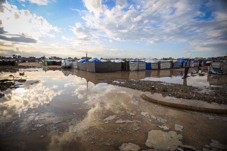 7gaza-1765358784 GAZA CITY, GAZA - DECEMBER 11: Palestinians struggle with flooding after heavy rain hits the Abu Marhil Camp in the Az-Zaytun neighborhood in Gaza City, Gaza on December 11, 2025. Conditions for displaced residents whose homes were destroyed in Israeli attacks, worsening as they continue to struggle not only with the devastation of the conflict but also with the deteriorating weather conditions. ( Hamza Z. H. Qraiqea - Anadolu Agency )