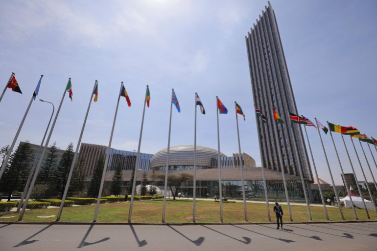 84513-1742763409 A delegate walks next to African Union (AU) member states flags ahead of the 38th Ordinary Session of the Heads of State and Government of the African Union at the African Union Commission (AUC) headquarters in Addis Ababa, Ethiopia, February 14, 2025. REUTERS/ Tiksa Negeri