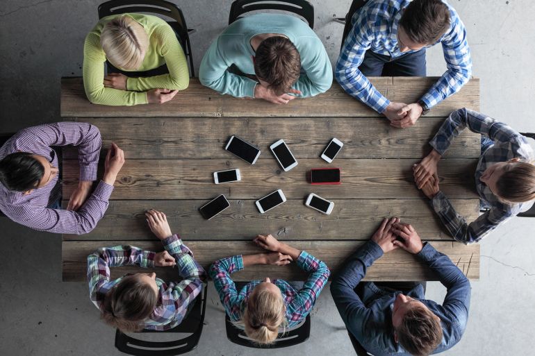 smartphones sitting around office table