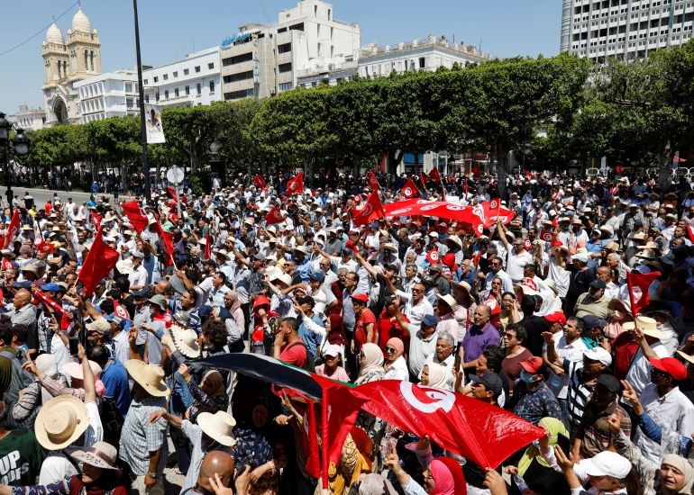 Demonstrators carry flags as they gather during a protest against Tunisian President Kais Saied in Tunis, Tunisia June 19, 2022. REUTERS/Zoubeir Souissi