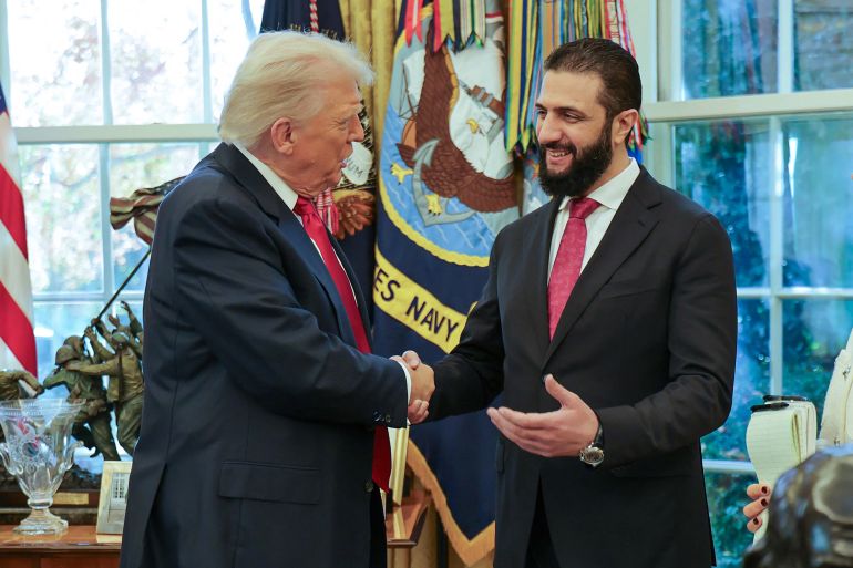 TOPSHOT - This handout photograph released by the official Syrian Arab News Agency (SANA) on November 10, 2025, shows US President Donald Trump (L) shaking hands with Syria's President Ahmed al-Sharaa at the White House in Washington DC.