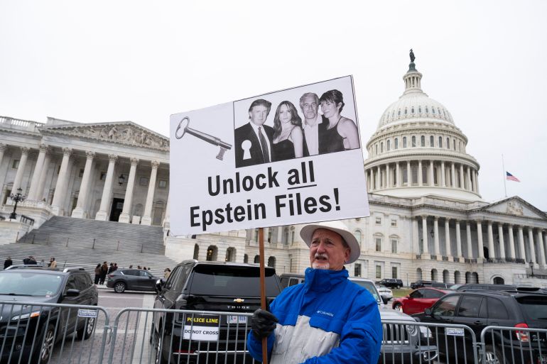 WASHINGTON, DC - NOVEMBER 18: A protester holds a placard after the House voted 427-1 to approve the Epstein Files Transparency Act and the release of documents and files at the U.S. Capitol on November 18, 2025 in Washington, DC. The legislation instructs the U.S. Department of Justice to release all files related to the late accused sex trafficker Jeffrey Epstein. It now goes to the Senate for a vote before President Donald Trump can sign it into law. Roberto Schmidt/Getty Images/AFP (Photo by ROBERTO SCHMIDT / GETTY IMAGES NORTH AMERICA / Getty Images via AFP)