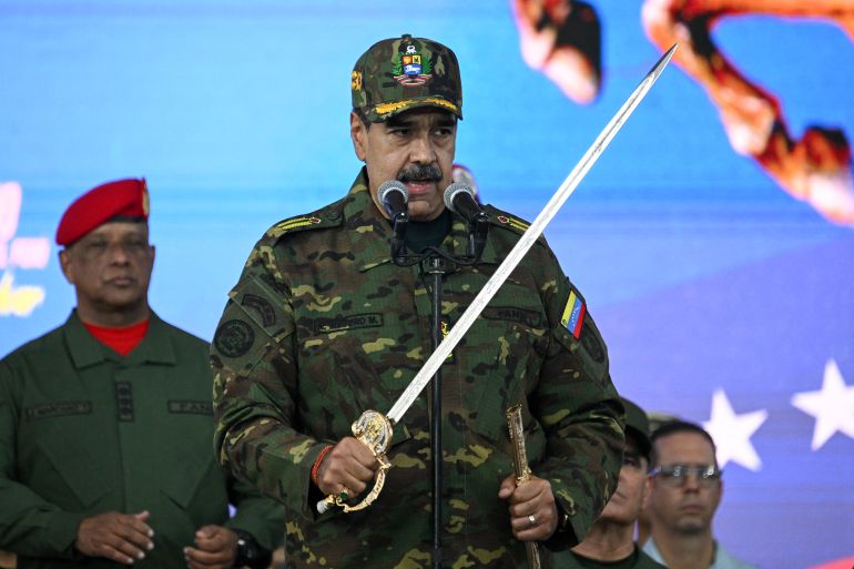 Venezuela's President Nicolas Maduro delivers a speech while holding the Venezuelan independence hero Simon Bolivar's 'Sword of Peru' during a military ceremony in Fuerte Tiuna, Caracas on November 25, 2025.