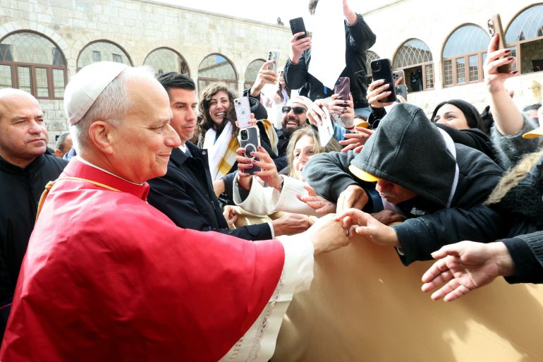afp_692d7183029f-1764585859 A handout made available by the Lebanese Presidency on December 1, 2025, shows Pope Leo XIV greeted by the faithful during his visit to the tomb of Saint Charbel Makhlouf or Mar Charbel in Arabic, a Lebanese Maronite monk and priest, at the Saint Maron monastery in the mountainous village of Annaya, north of the capital Beirut on December 1, 2025.