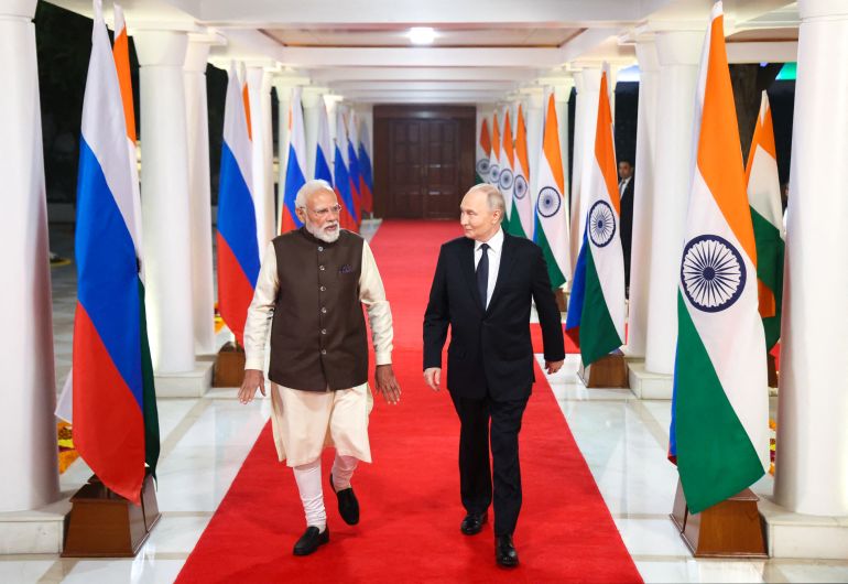 afp_69326c9ca39d-1764912284 In this pool photograph distributed by the Russian state agency Sputnik, Russia's President Vladimir Putin and Indian Prime Minister Narendra Modi walk prior to an informal dinner at Modi's residence in New Delhi on December 4, 2025, the first day of the Russian leader's two-day state visit to India. (Photo by Alexander KAZAKOV / POOL / AFP)