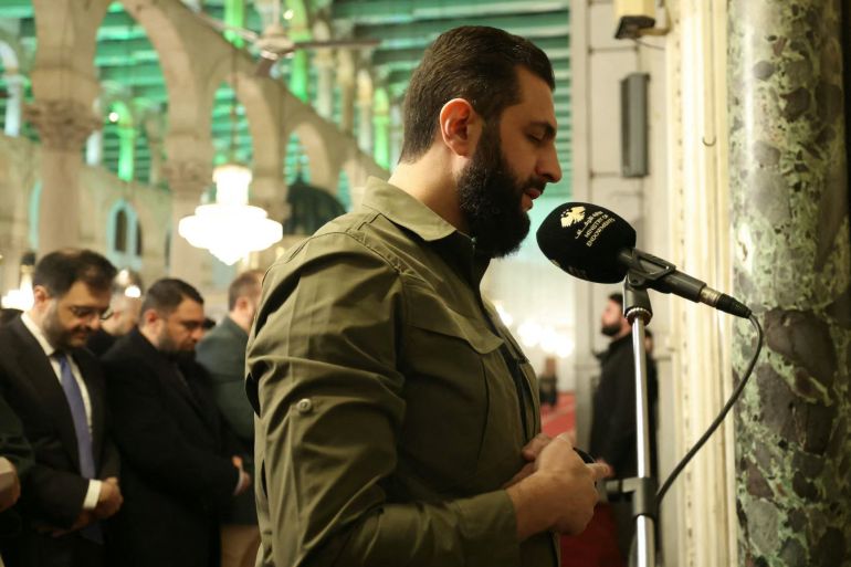 This handout photograph released by the official Syrian Arab News Agency (SANA) on December 8, 2025, shows Syria's President Ahmed al-Sharaa lead prayers at Umayyad Mosque in Damascus during the anniversary of the ousting of longtime ruler Bashar al-Assad.