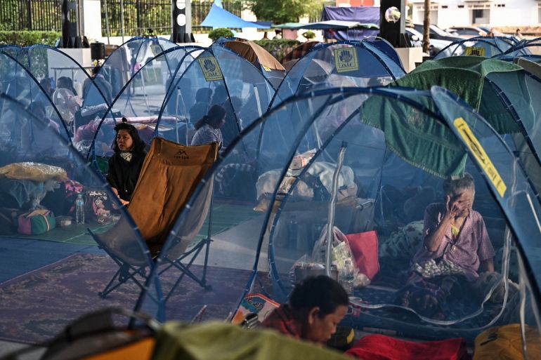 afp_6939171aa881-1765349146 TOPSHOT - Displaced residents rest as they take shelter at an evacuee center during clashes along the Thai-Cambodia border in Thailand's Sa Kaeo Province on December 10, 2025.