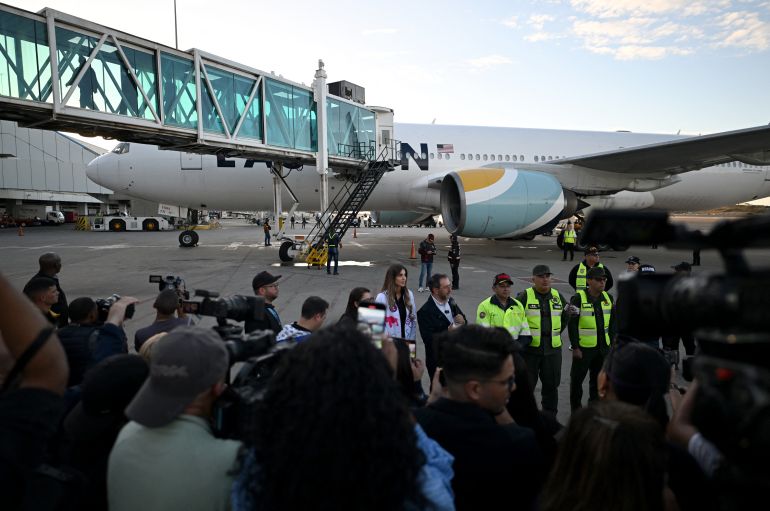 afp_693a50a4c979-1765429412 Venezuela's Foreign Minister Yvan Gil speaks to the media in front of an Eastern Airlines plane carrying Venezuelan migrants repatriated from the US after landing at Simon Bolivar International Airport in Maiquetia, Venezuela, on December 3, 2025.