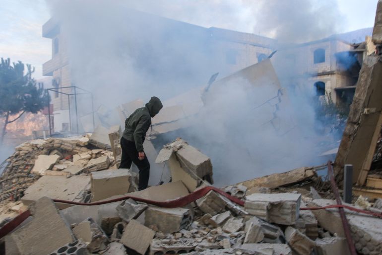 A man looks inspects the damage at the site of an Israeli airstrike that targeted the southern Lebanese village of Jbaa on December 4, 2025.