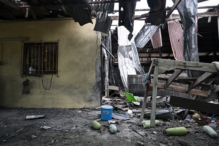 afp_693aa73240c8-1765451570 Damage to an evacuated house is pictured after being hit by Cambodian artillery at a village close to the Thai-Cambodia border in Surin province on December 11, 2025.