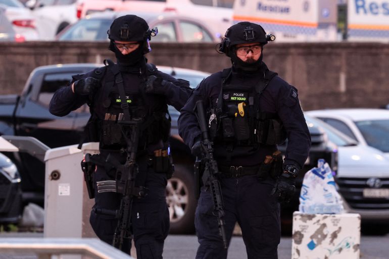 afp_693e8e98d229-1765707416 Armed police work at the scene after a shooting incident at Bondi Beach in Sydney on December 14, 2025.