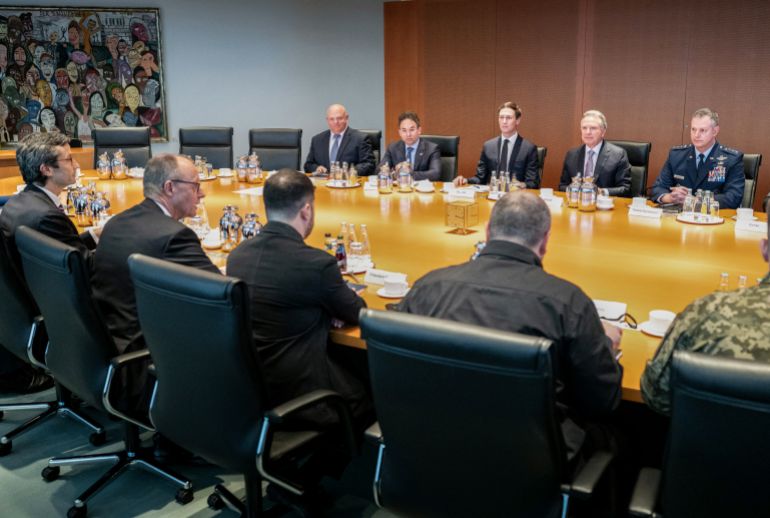 afp_693efa4a0a43-1765734986 This handout photo released on December 14, 2025 by the German government's press service shows (front row L-R) Foreign and security policy advisor Guenter Sautter, German Chancellor Friedrich Merz, Ukraine's President Volodymyr Zelensky, Secretary of the National Security and Defense Council of Ukraine Rustem Umerov, facing the US delegation, among them US President Donald Trump's son-in-law Jared Kushner (back row C) and US special envoy Steve Witkoff (back row 2ndR) at the start of their meeting in a conference room in the Chancellery in Berlin, on December 14, 2025.